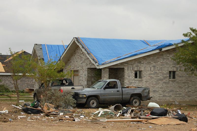 Blue roof tarps on homes after a storm